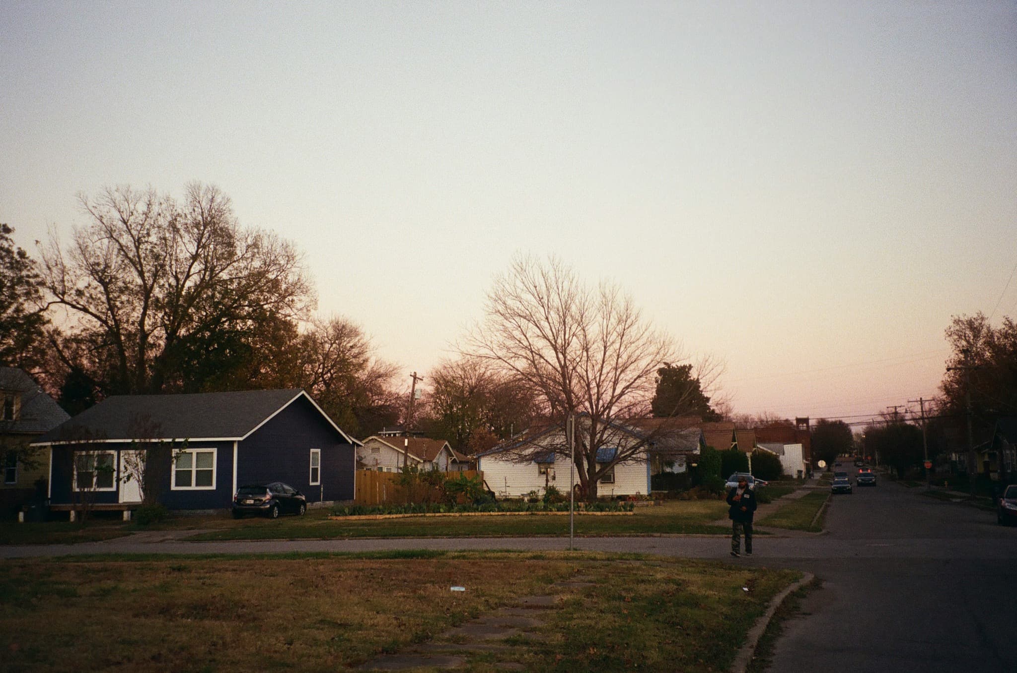 Couple packing boxes in a living room filled with cardboard boxes, looking at a tablet